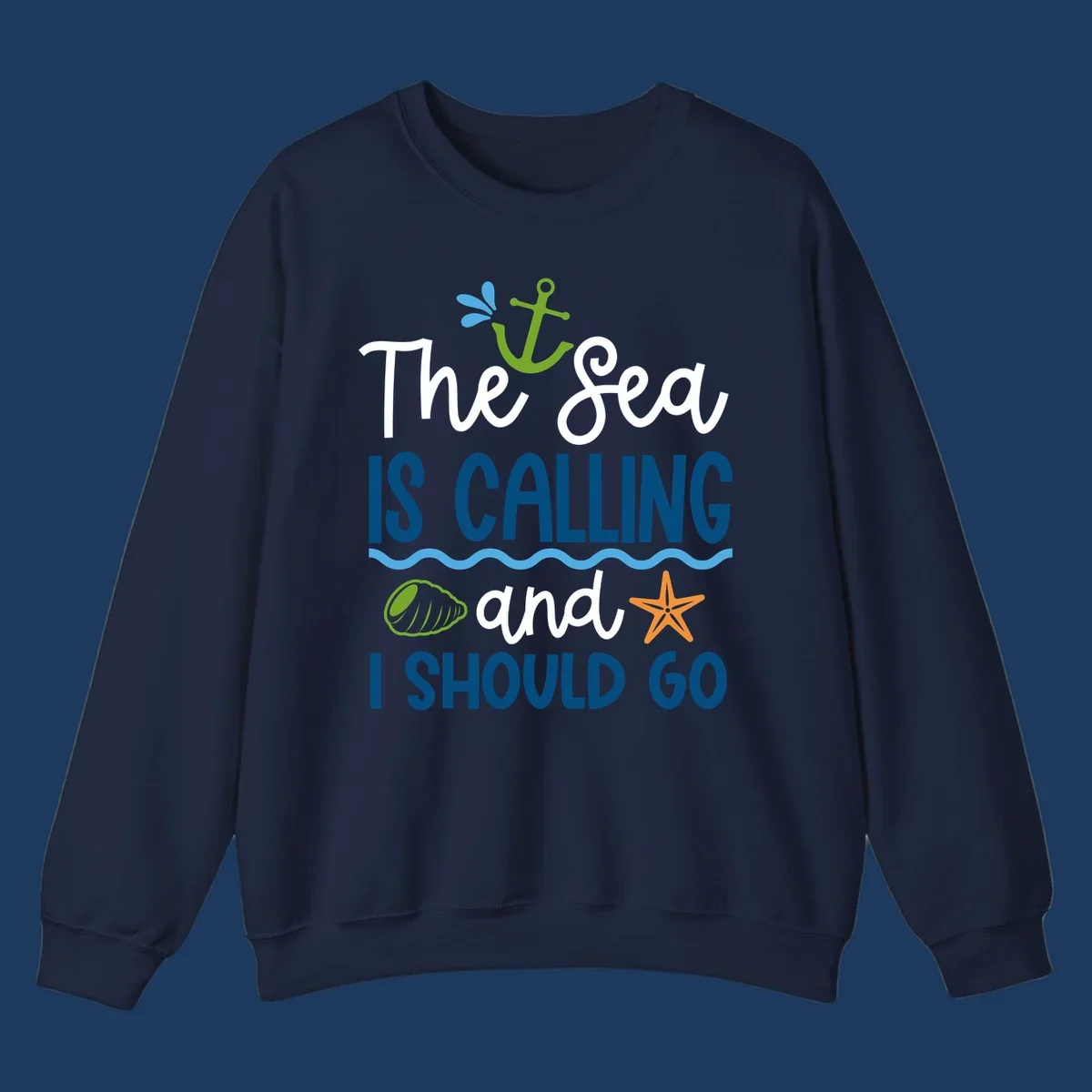 Gray tee design with 'The Sea Is Calling and I Should Go' text in white and blue, decorated with nautical icons including anchor, starfish, seashell, and ocean waves.