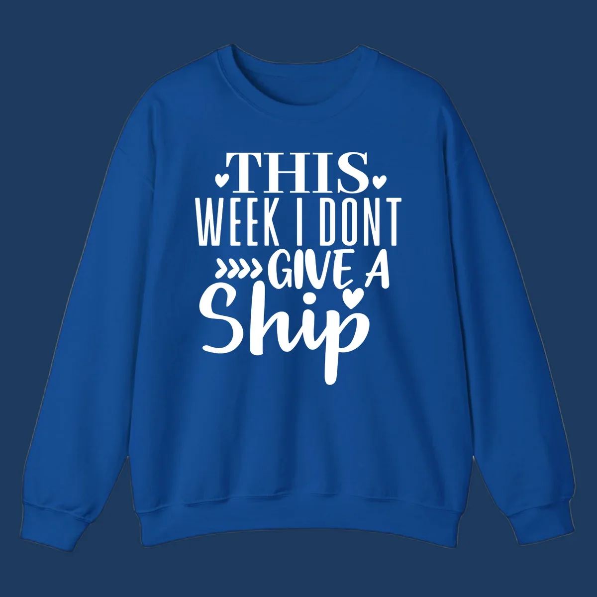 White text on gray background reading 'This Week I Don't Give A Ship' with hearts and arrows, a playful cruise humor design