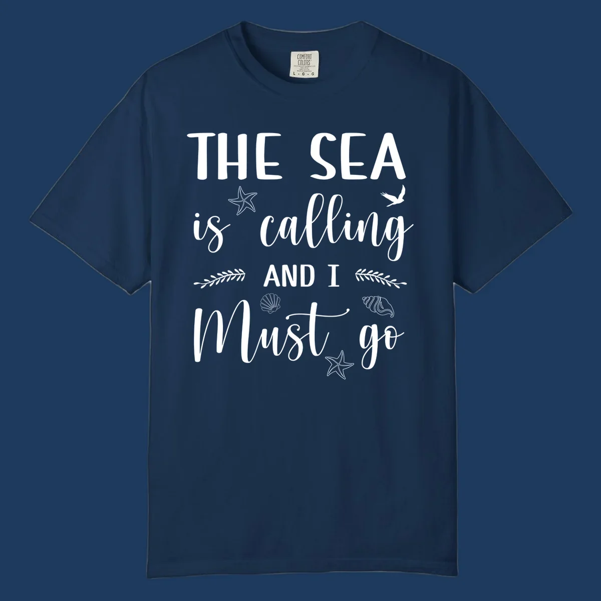 Gray design with white text reading 'The Sea is calling AND I MUST go' surrounded by starfish, seashells, a flying bird, and leaf accents