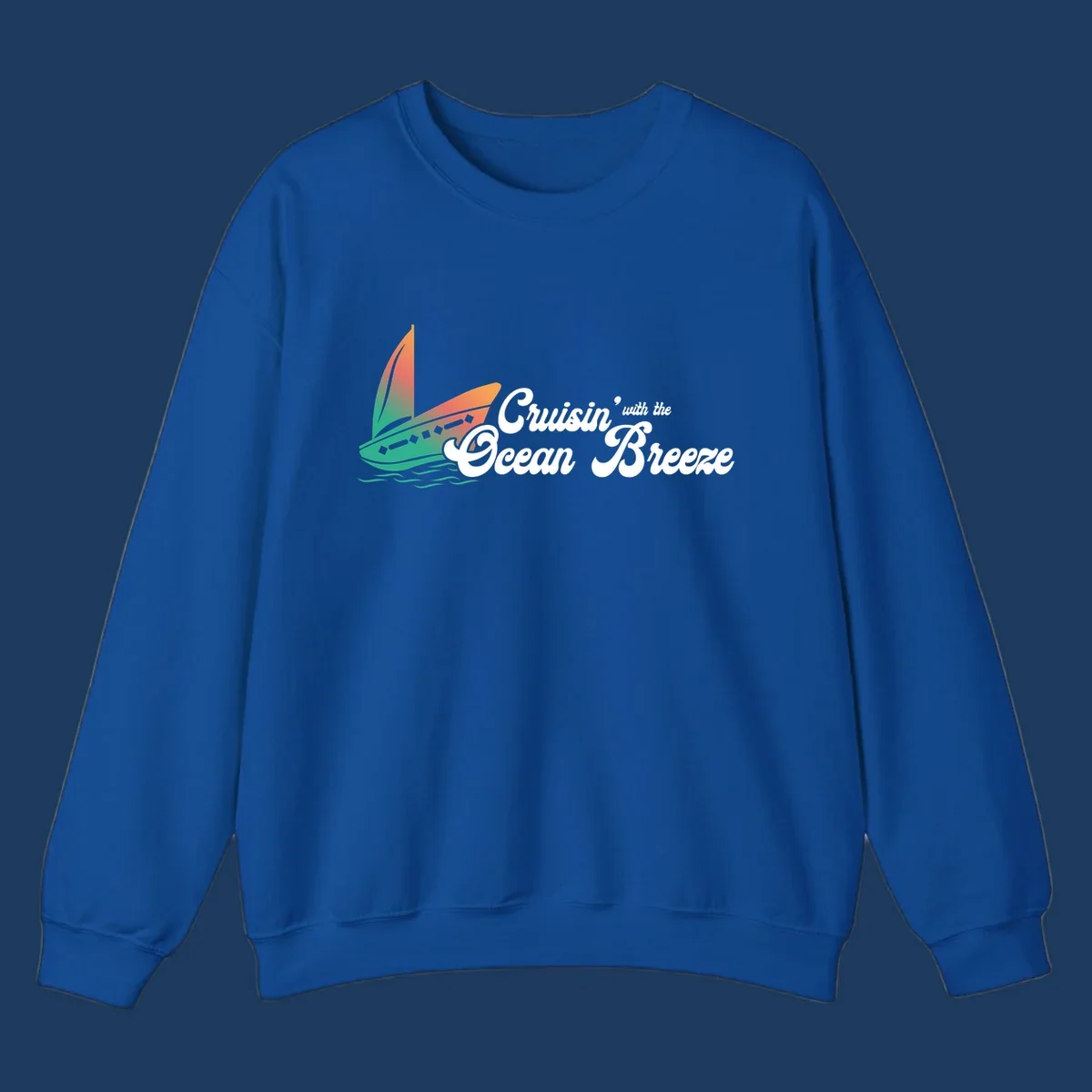 Sailboat with gradient orange-to-green sail on ocean waves with 'Cruisin' with the Ocean Breeze' text in white script