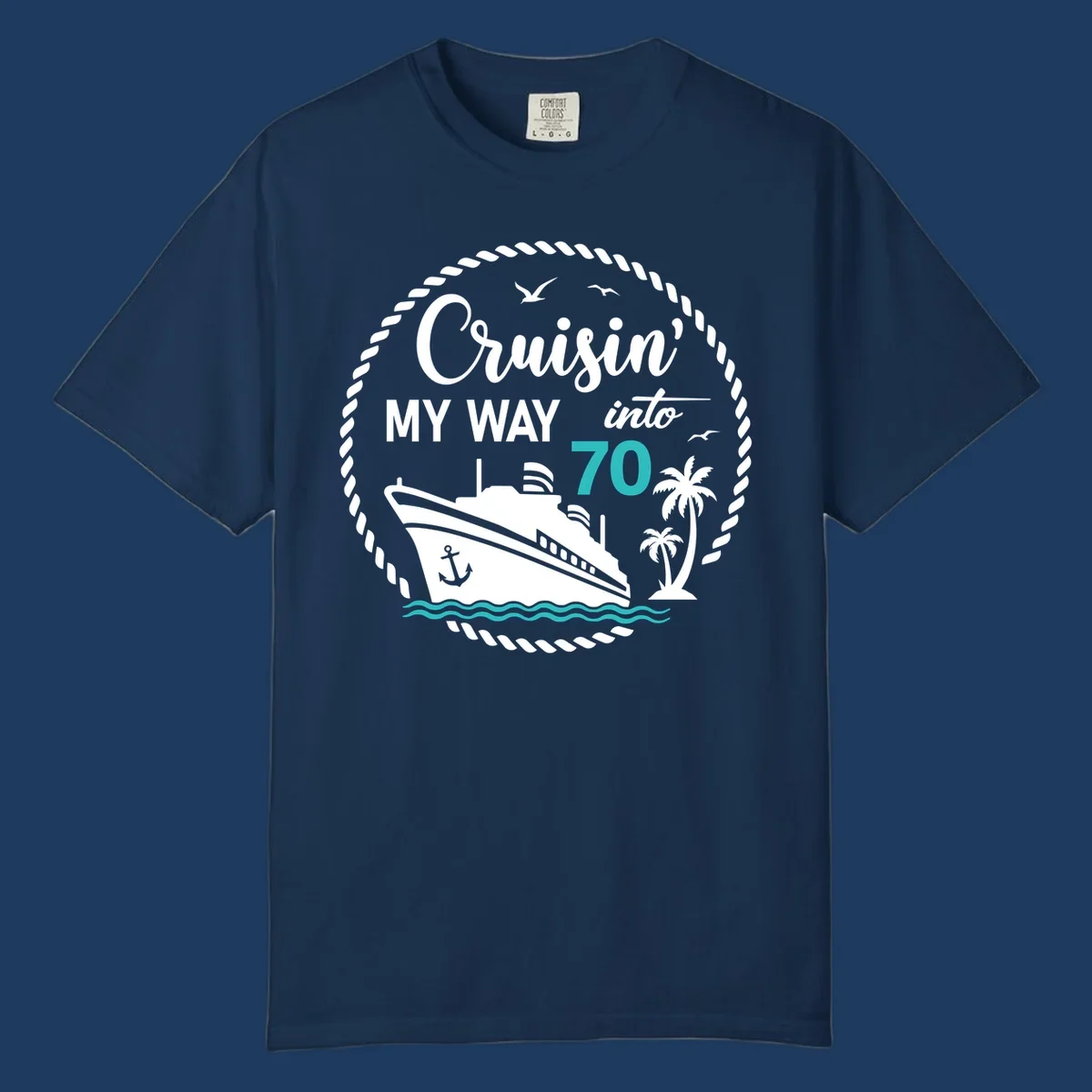 Nautical 70th birthday design with cruise ship, palm trees, and waves. Text reads 'Cruisin' MY WAY into 70' in white and teal on gray background.