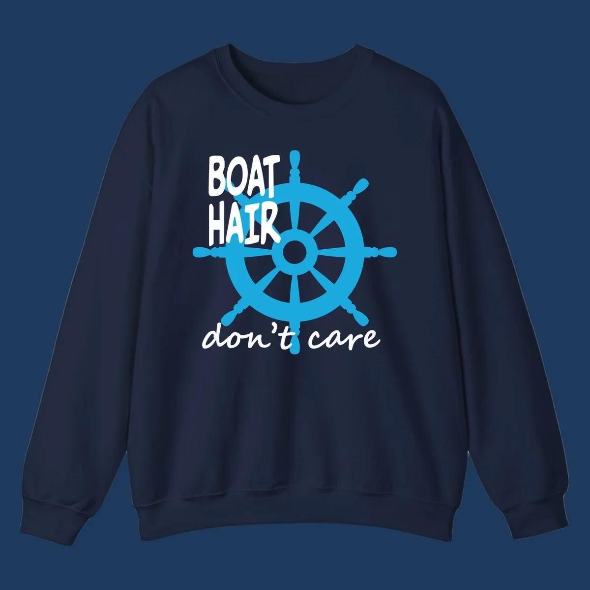 Blue ship's wheel graphic with white text reading 'BOAT HAIR don't care' - nautical cruise humor design