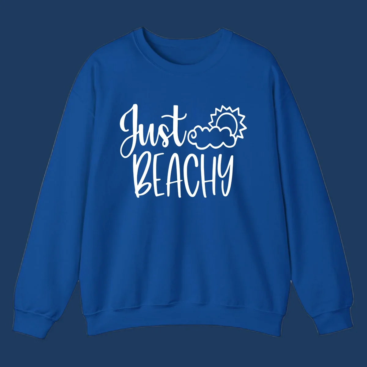 White illustrated text reading 'Just Beachy' with a smiling sun and cloud graphic, capturing beach vacation vibes