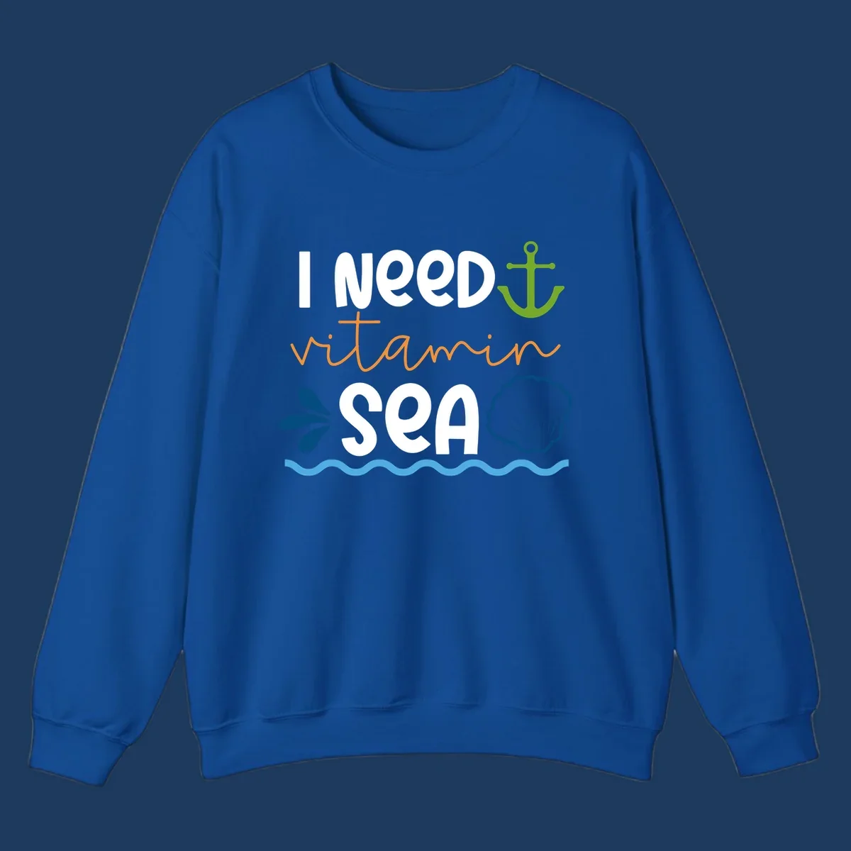 Nautical design with white text reading 'I Need Vitamin Sea' surrounded by anchor, shells, waves, and water droplets in orange, green, and blue