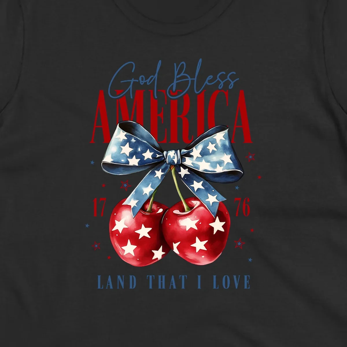 A patriotic design featuring 'God Bless AMERICA' and 'LAND THAT I LOVE' with a blue star-spangled bow, two red star-covered cherries, and the numbers '17' and '76'. god-bless-america-cherries.