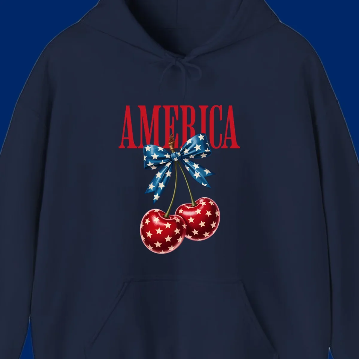The word AMERICA in red above two red, white, and blue star-spangled cherries tied with a star bow. Features america-patriotic-cherries.
