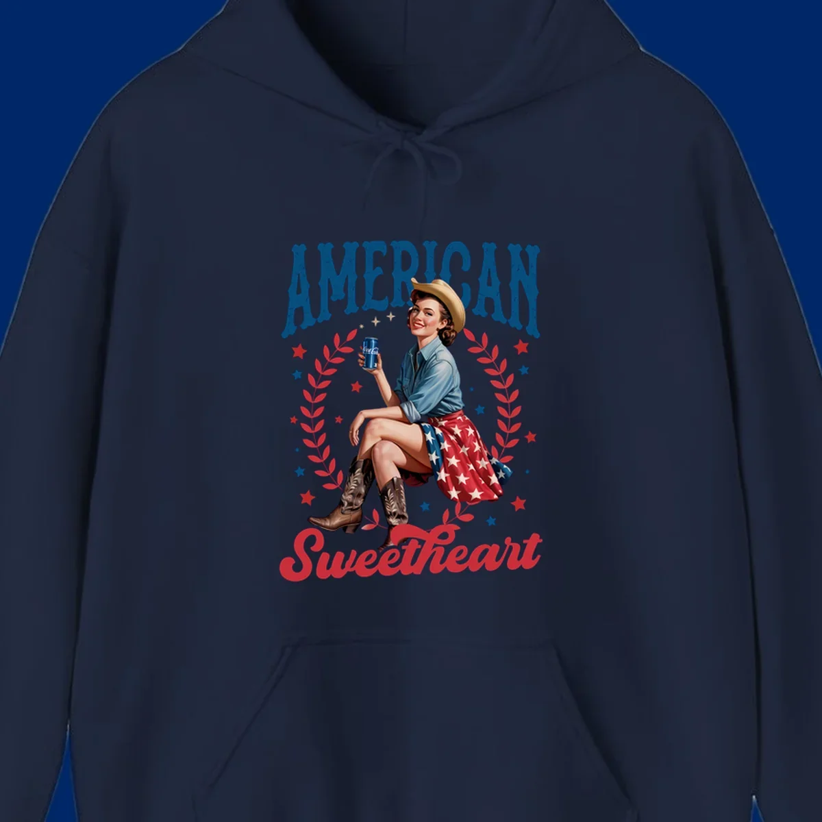 A vintage American sweetheart pin-up girl wearing a cowboy hat and American flag skirt, holding a Coca-Cola can, framed by leaves and stars, with 'AMERICAN Sweetheart' text. This american-sweetheart-pin-up design is perfect for celebrating.