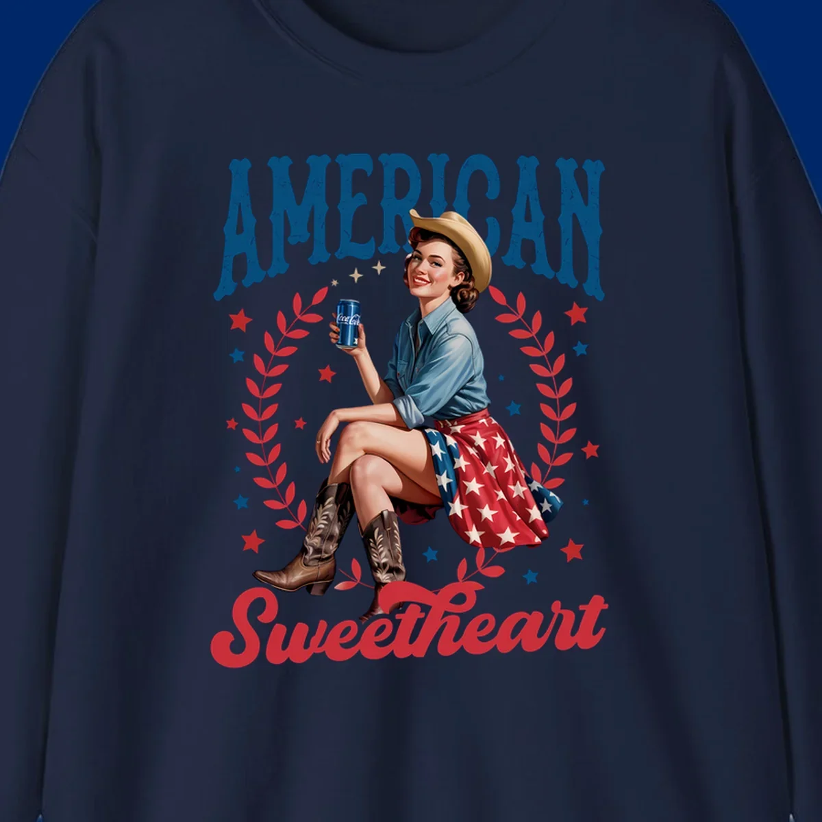 A vintage American sweetheart pin-up girl wearing a cowboy hat and American flag skirt, holding a Coca-Cola can, framed by leaves and stars, with 'AMERICAN Sweetheart' text. This american-sweetheart-pin-up design is perfect for celebrating.
