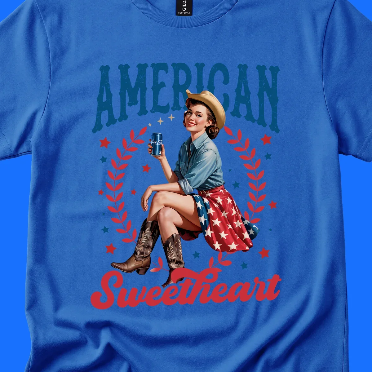 A vintage American sweetheart pin-up girl wearing a cowboy hat and American flag skirt, holding a Coca-Cola can, framed by leaves and stars, with 'AMERICAN Sweetheart' text. This american-sweetheart-pin-up design is perfect for celebrating.