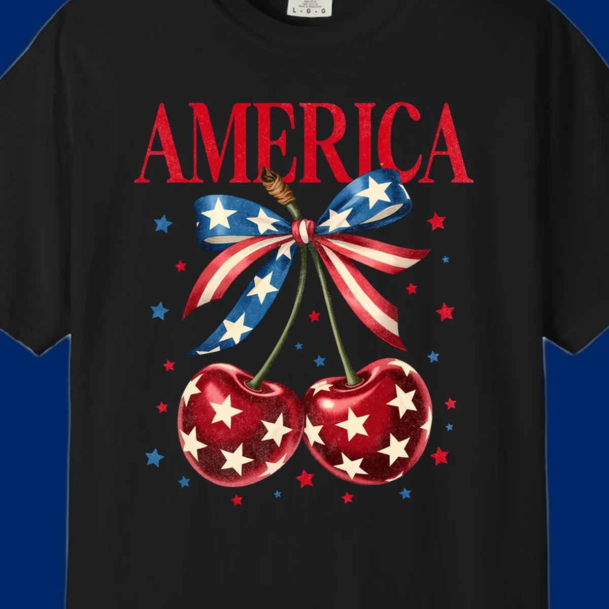 Vintage patriotic artwork featuring red 'AMERICA' text, two red cherries with white stars, and an American flag ribbon. Scattered red and blue stars complete this America-cherries-stars design.