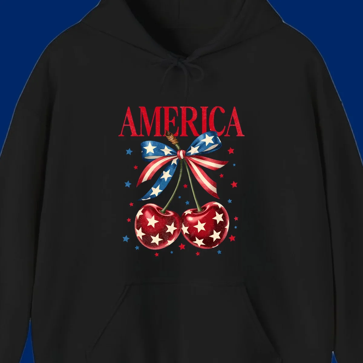 Vintage patriotic artwork featuring red 'AMERICA' text, two red cherries with white stars, and an American flag ribbon. Scattered red and blue stars complete this America-cherries-stars design.