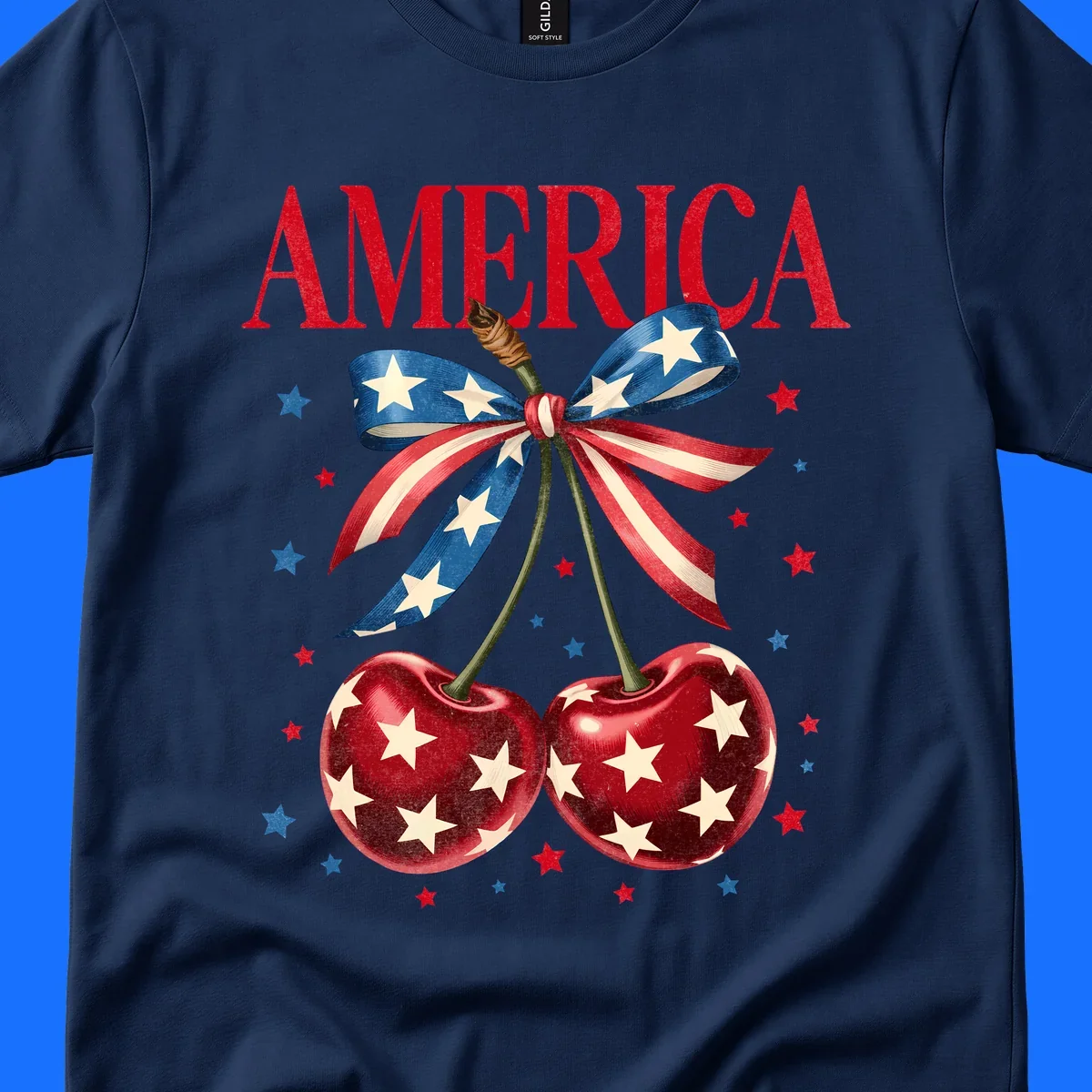 Vintage patriotic artwork featuring red 'AMERICA' text, two red cherries with white stars, and an American flag ribbon. Scattered red and blue stars complete this America-cherries-stars design.