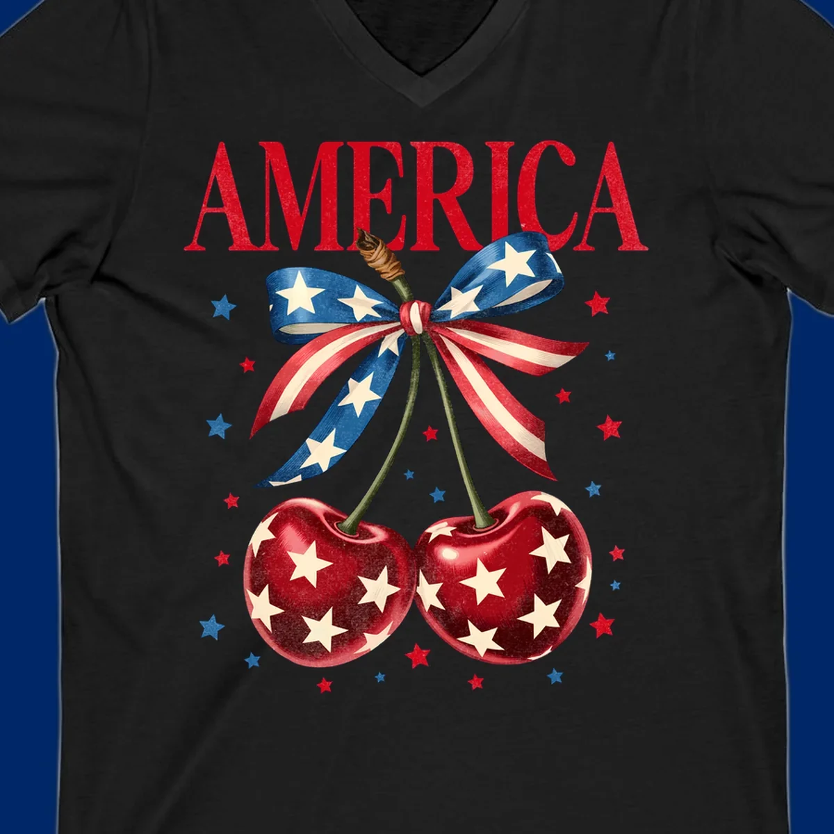 Vintage patriotic artwork featuring red 'AMERICA' text, two red cherries with white stars, and an American flag ribbon. Scattered red and blue stars complete this America-cherries-stars design.