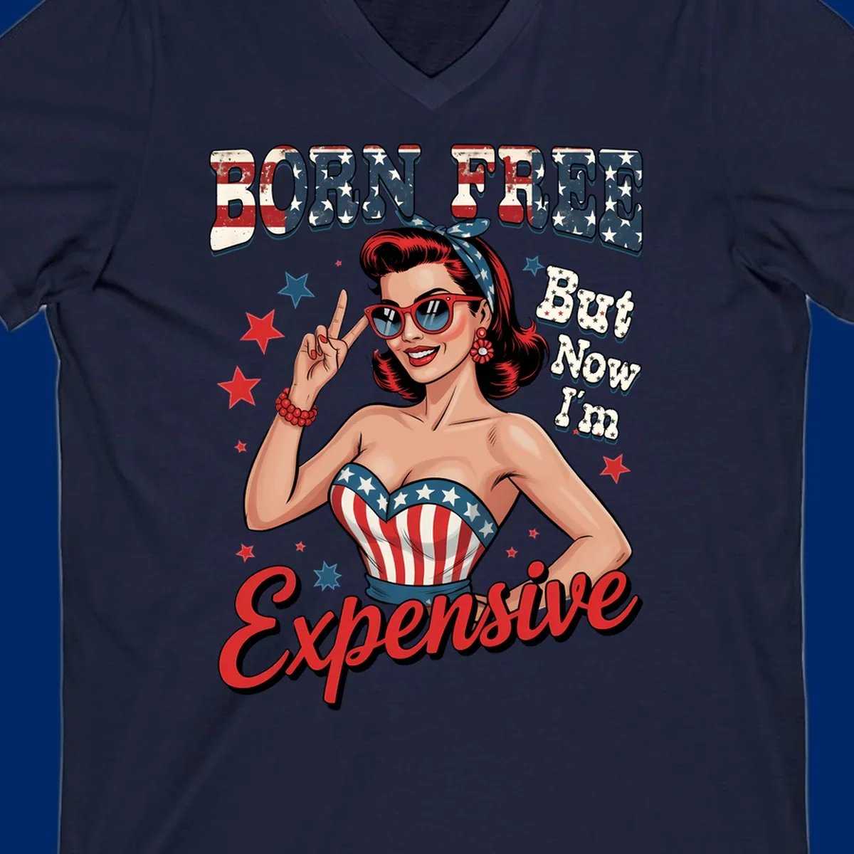 Retro pin-up girl making a peace sign, wearing a stars and stripes top, with the text 'BORN FREE But Now I'm Expensive'. This born-free-expensive-pin-up design is patriotic and fun.