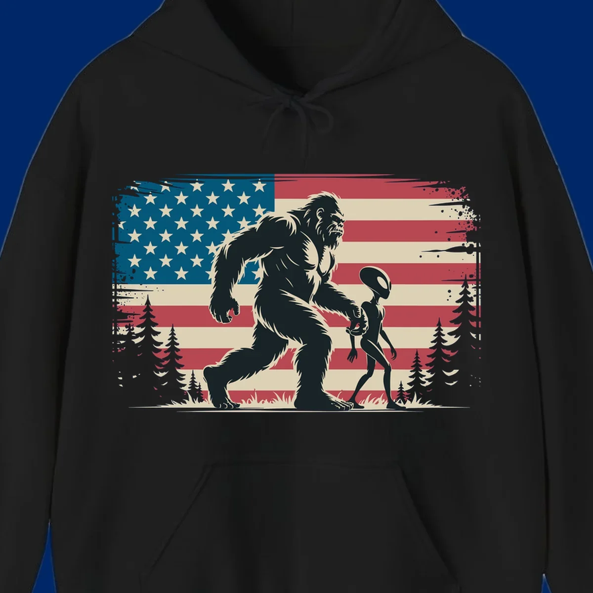 A vintage illustration of Bigfoot and a grey alien walking through a forest, set against a distressed bigfoot-alien-american-flag.