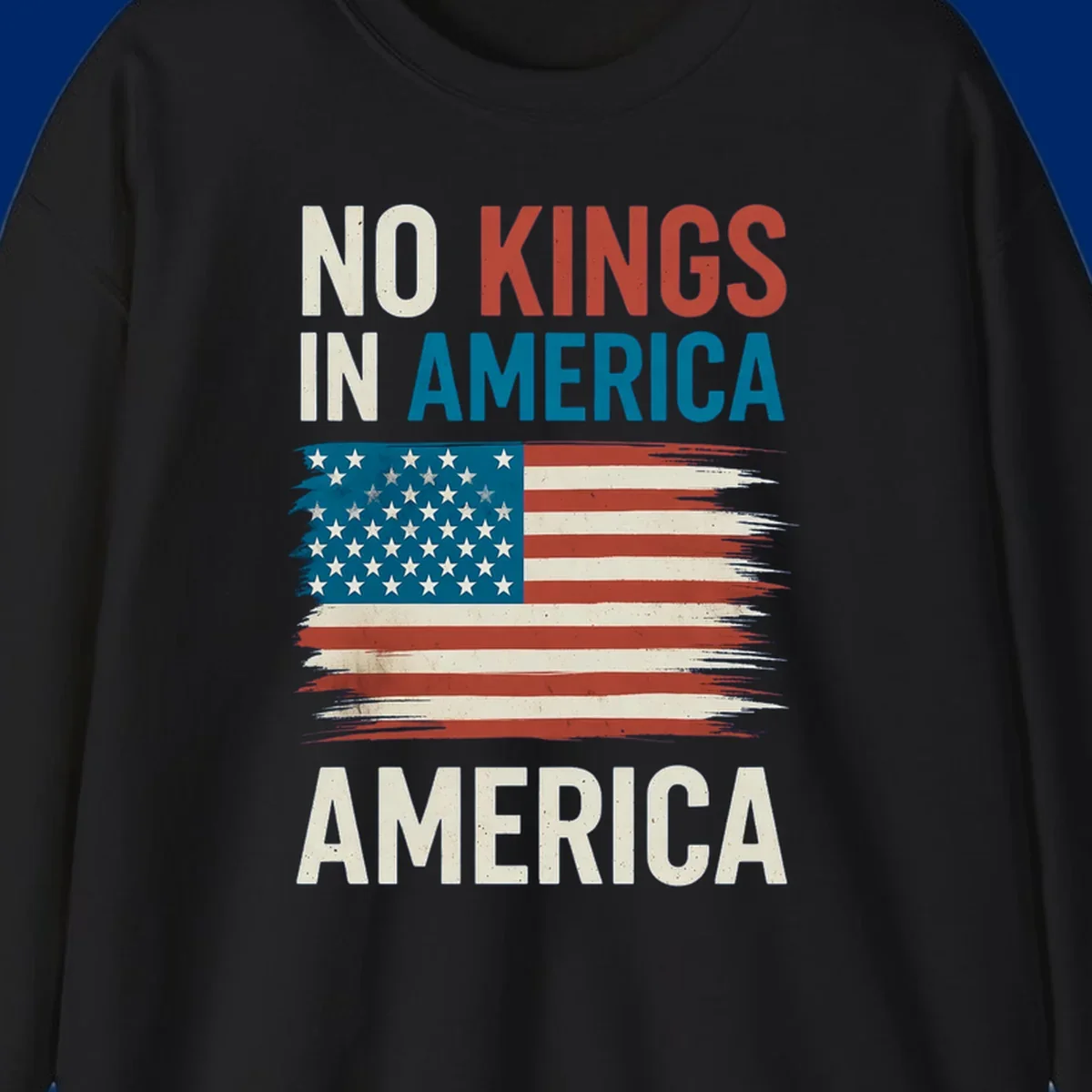 Distressed American flag design with the text 'NO KINGS IN AMERICA' above and 'AMERICA' below, representing the no-kings-in-america-flag concept.