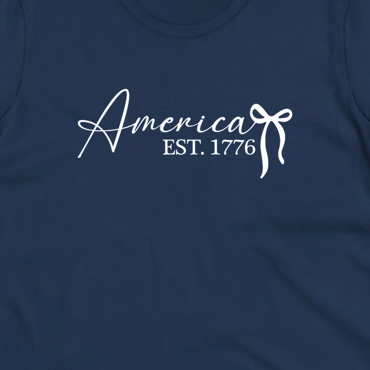 White script text "America" with decorative flourishes above "EST. 1776" in serif font, on a black background. Design for america-est-1776.