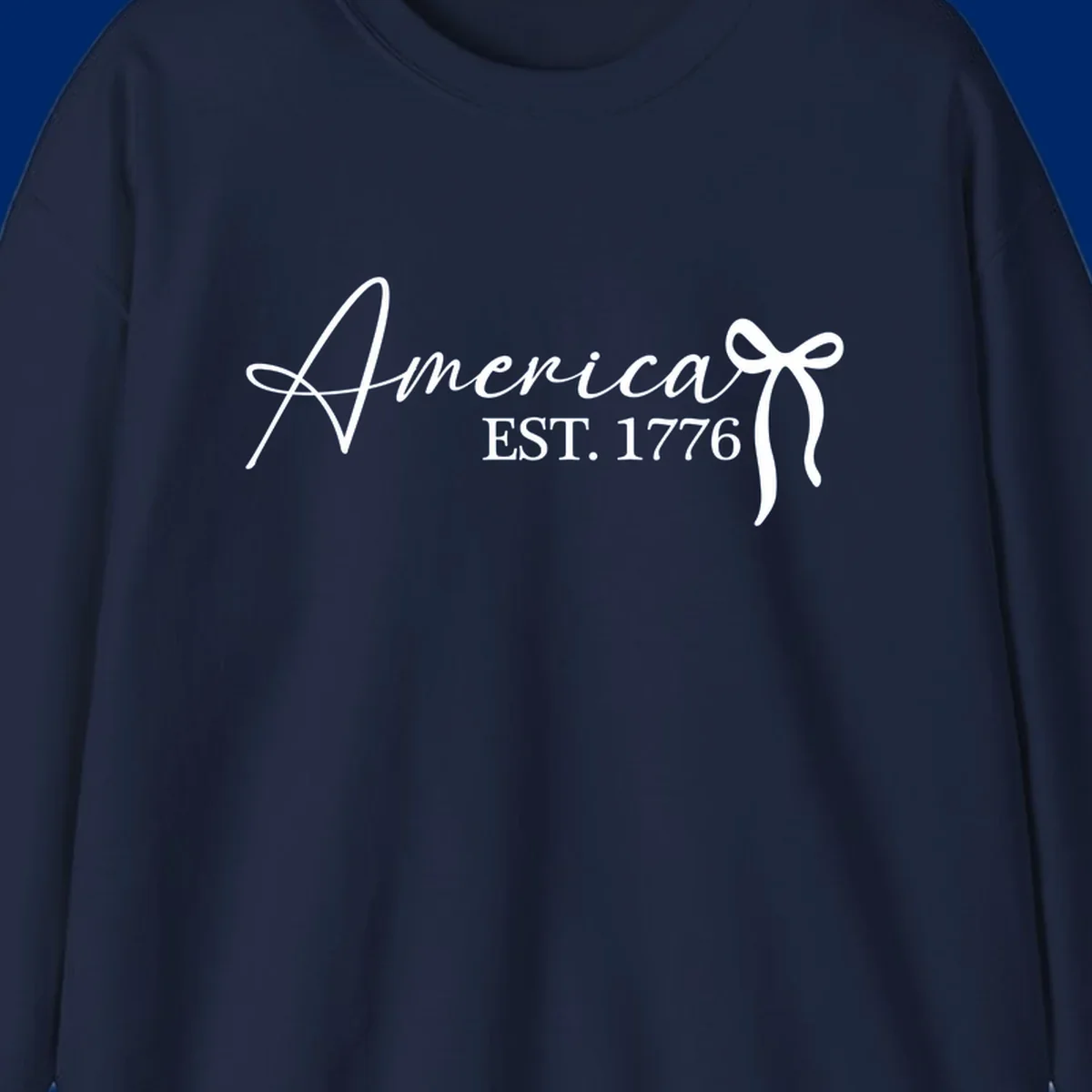White script text "America" with decorative flourishes above "EST. 1776" in serif font, on a black background. Design for america-est-1776.