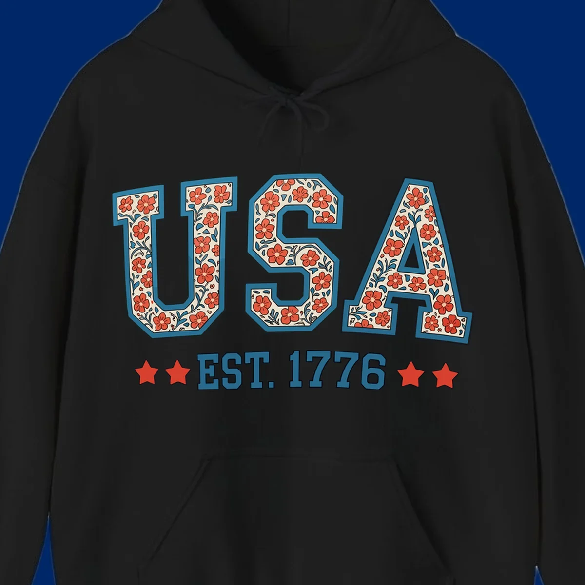 Illustrated text 'USA' with red flowers and blue leaves, above blue 'EST. 1776' text flanked by red stars. Concept: usa-est-1776-floral.