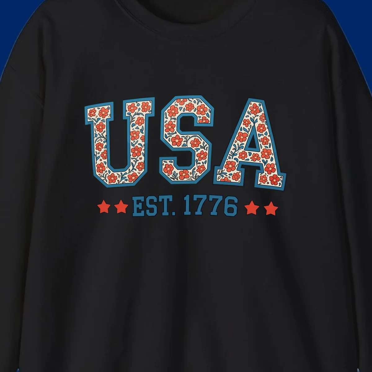 Illustrated text 'USA' with red flowers and blue leaves, above blue 'EST. 1776' text flanked by red stars. Concept: usa-est-1776-floral.