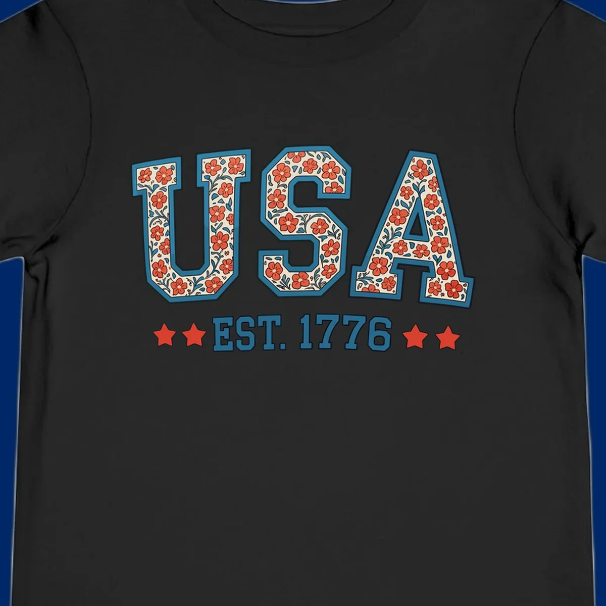 Illustrated text 'USA' with red flowers and blue leaves, above blue 'EST. 1776' text flanked by red stars. Concept: usa-est-1776-floral.