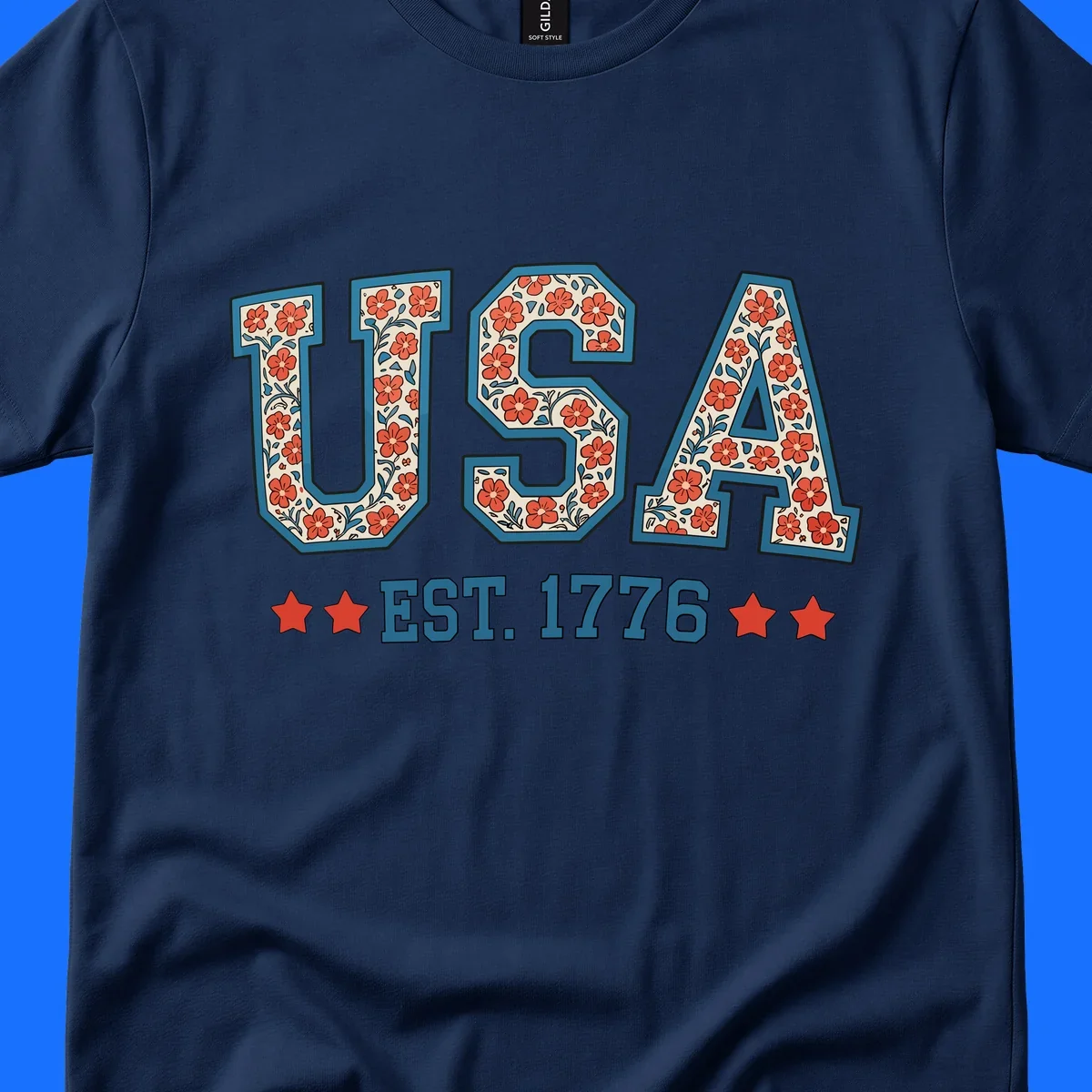 Illustrated text 'USA' with red flowers and blue leaves, above blue 'EST. 1776' text flanked by red stars. Concept: usa-est-1776-floral.