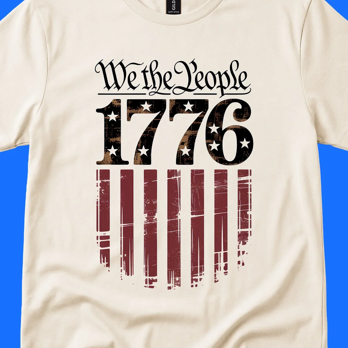 A distressed patriotic design featuring 'We the People' in script, '1776' with stars, and red stripes below, embodying the we-the-people-1776-flag theme.