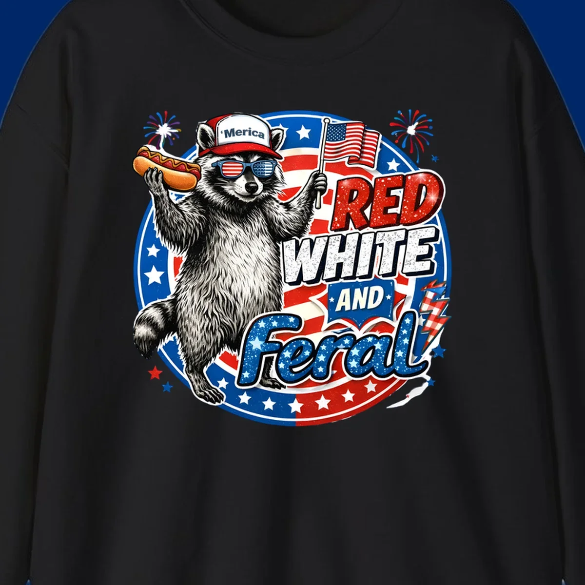 A patriotic-raccoon-feral illustration of a raccoon in a 'Merica hat, flag sunglasses, holding a hotdog and US flag. Text: RED WHITE AND Feral.