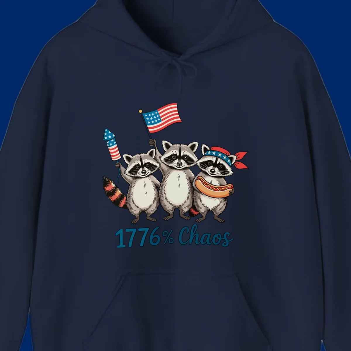 Illustration of three patriotic raccoons celebrating with an American flag, firework, and hot dog, with '1776% Chaos' text. Represents 1776-chaos-raccoons-celebration.