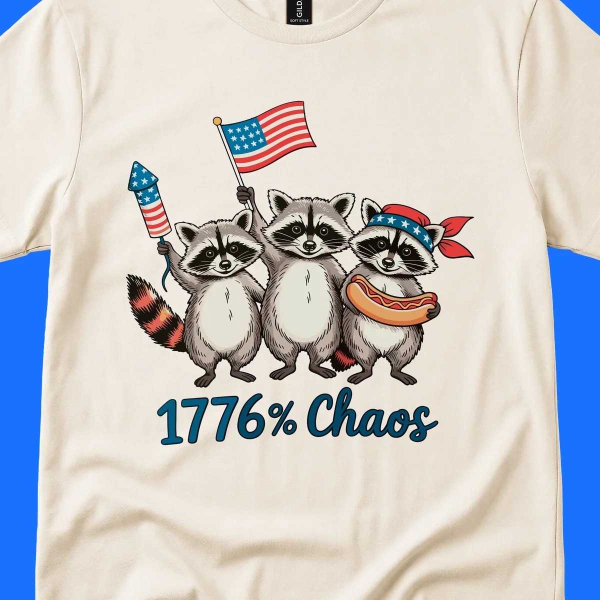 Illustration of three patriotic raccoons celebrating with an American flag, firework, and hot dog, with '1776% Chaos' text. Represents 1776-chaos-raccoons-celebration.