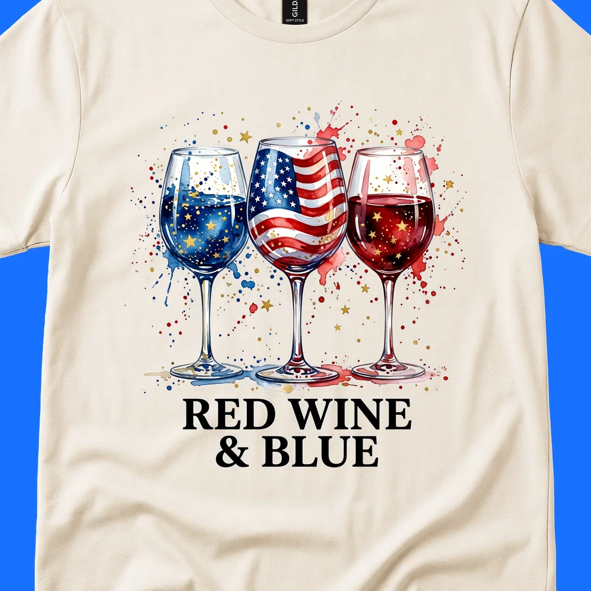 Watercolor illustration of three wine glasses, one with an American flag, one with blue liquid and gold stars, and one with red liquid and gold stars, with the text 'RED WINE & BLUE'. This red-wine-blue-patriotic design celebrates American heritage.