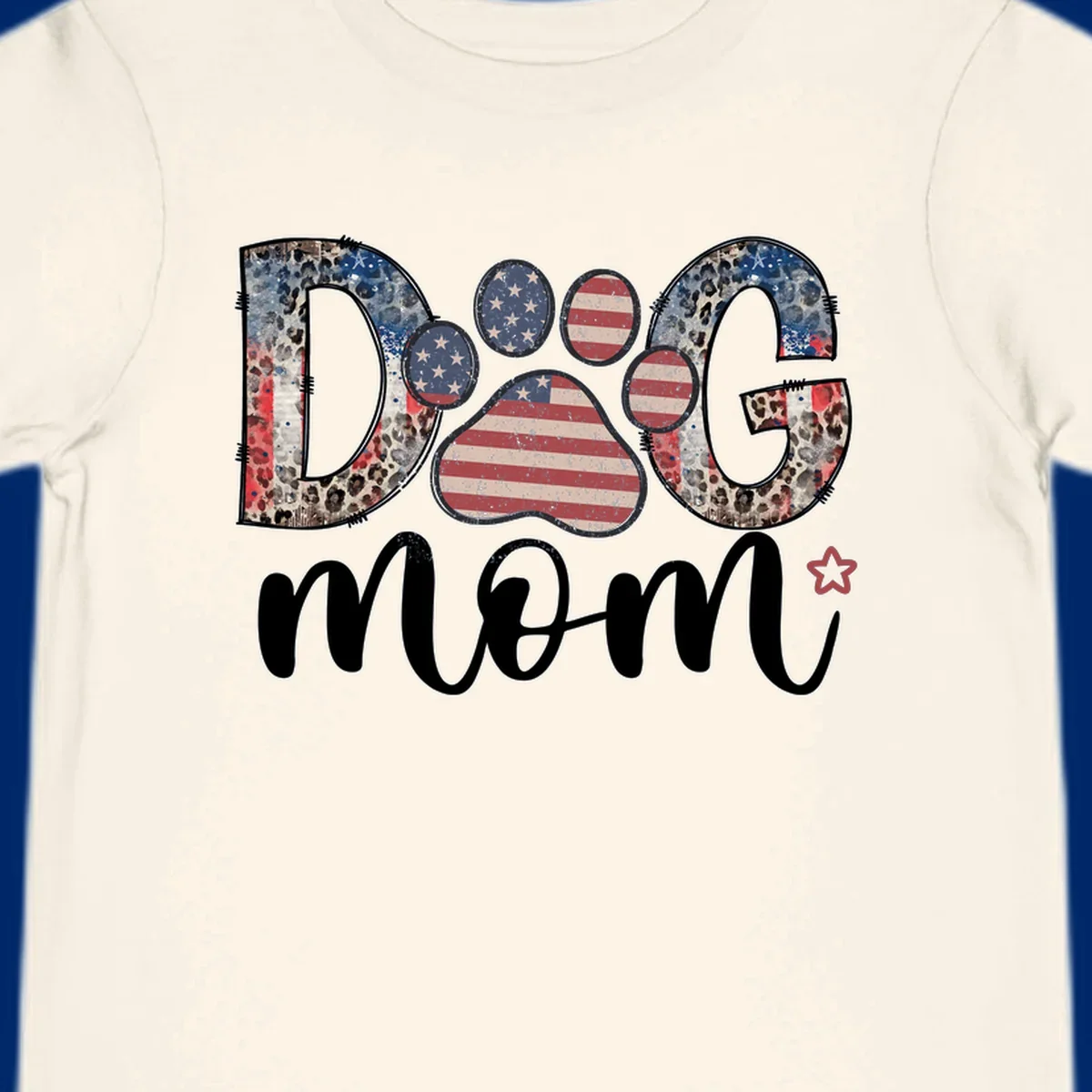 A graphic spelling 'DOG' with a patriotic-dog-paw-print. The 'D' and 'G' have leopard print and flag elements, and the 'O' is a flag paw print.
