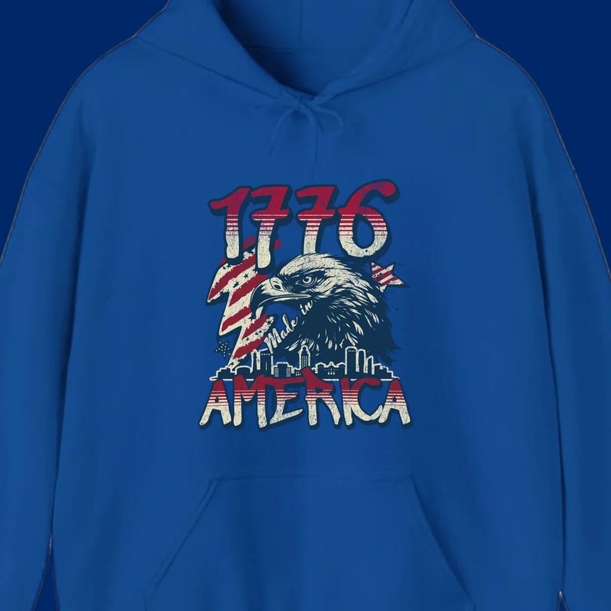 Vintage 1776 Made in America design with a bald eagle, city skyline, and American flag pattern. Features distressed red, cream, and navy colors.