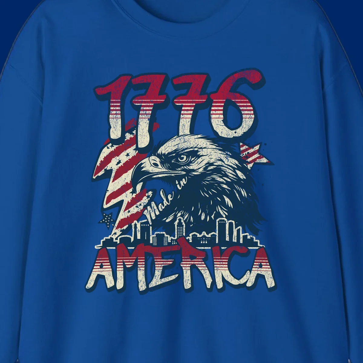 Vintage 1776 Made in America design with a bald eagle, city skyline, and American flag pattern. Features distressed red, cream, and navy colors.