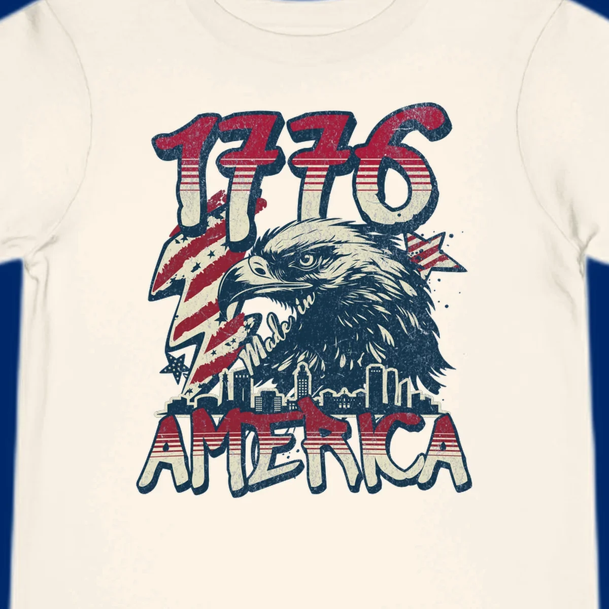Vintage 1776 Made in America design with a bald eagle, city skyline, and American flag pattern. Features distressed red, cream, and navy colors.