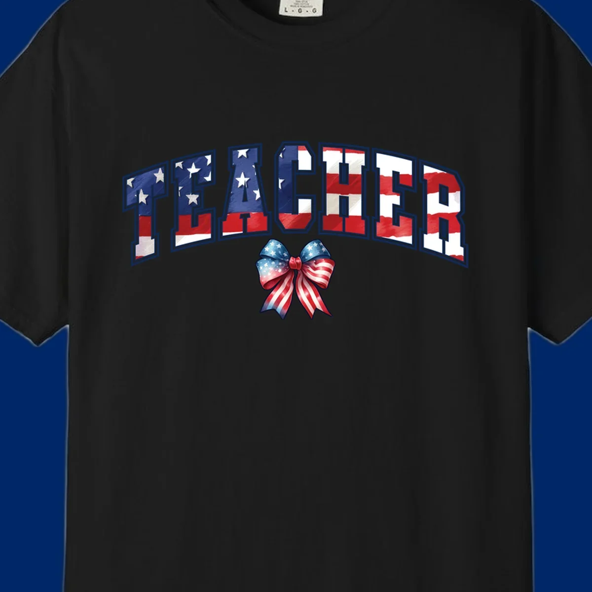 The word TEACHER in arched letters filled with an American flag pattern, featuring stars and stripes, with a patriotic bow below. Primary keyword root: patriotic-teacher-bow.