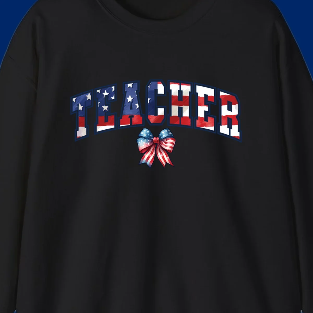 The word TEACHER in arched letters filled with an American flag pattern, featuring stars and stripes, with a patriotic bow below. Primary keyword root: patriotic-teacher-bow.