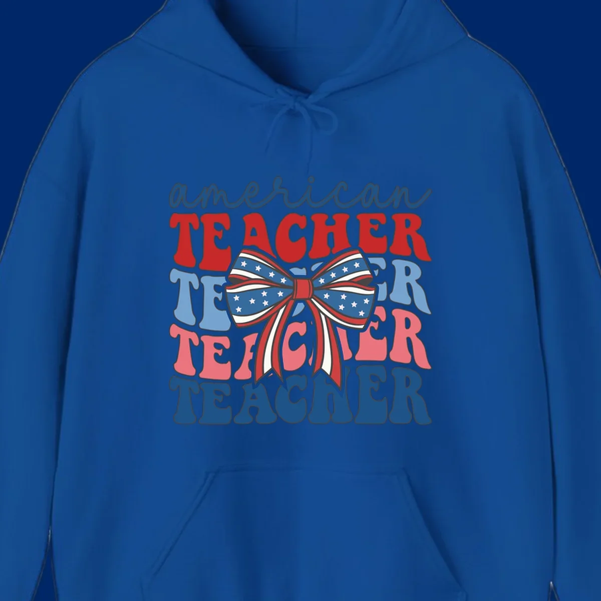A graphic design reading 'american TEACHER' with the word TEACHER repeated four times, featuring a large patriotic American flag bow with stars and stripes. The text is in red, blue, and pink colors, outlined in dark gray.