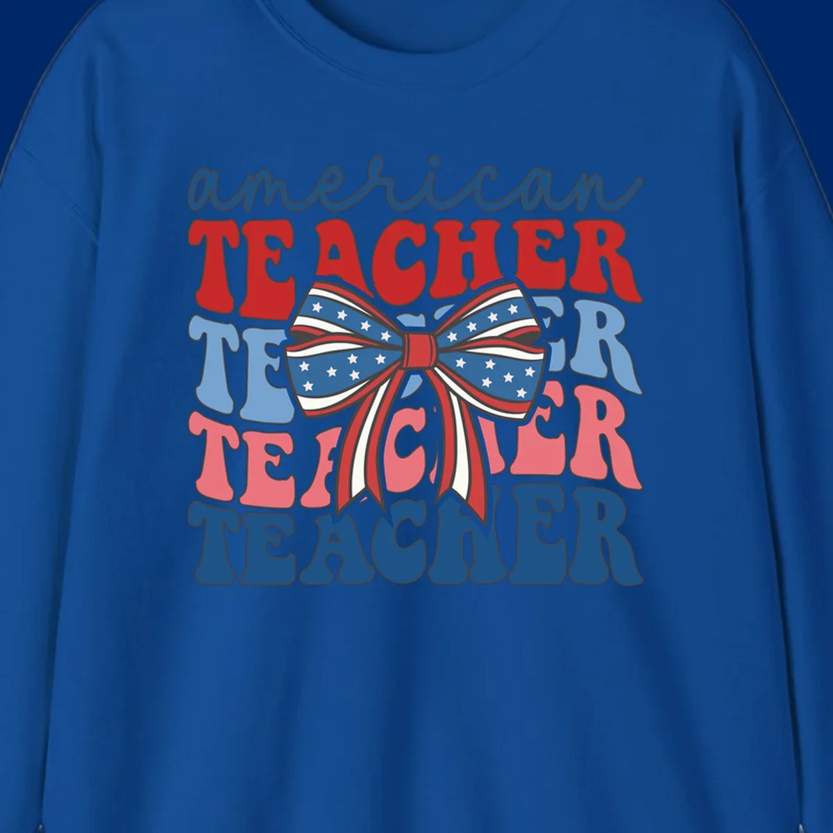 A graphic design reading 'american TEACHER' with the word TEACHER repeated four times, featuring a large patriotic American flag bow with stars and stripes. The text is in red, blue, and pink colors, outlined in dark gray.