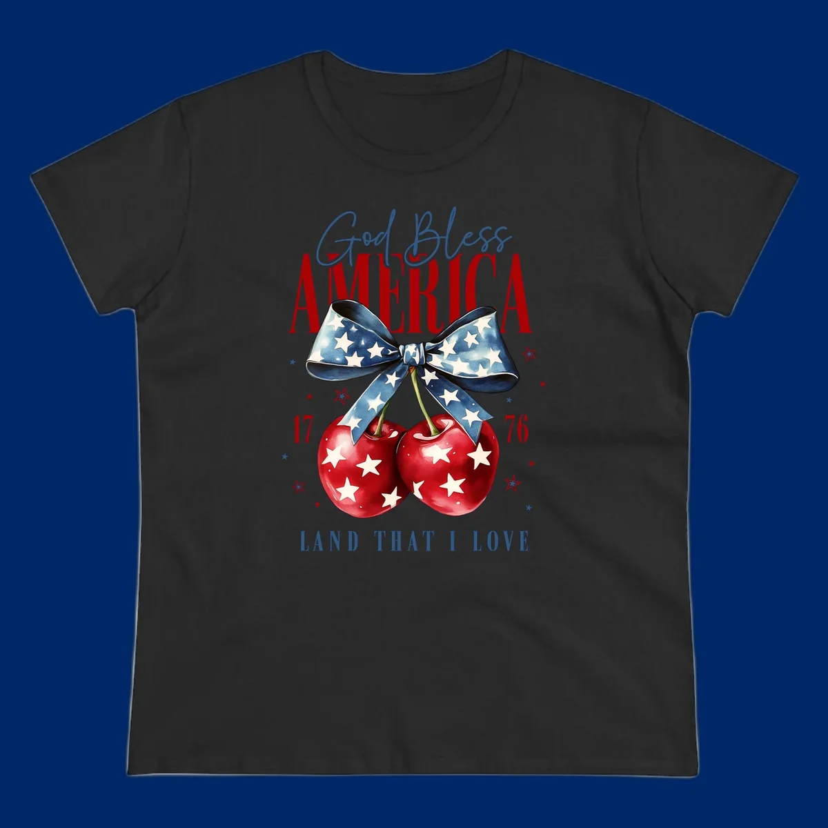 A patriotic design featuring 'God Bless AMERICA' and 'LAND THAT I LOVE' with a blue star-spangled bow, two red star-covered cherries, and the numbers '17' and '76'. god-bless-america-cherries.