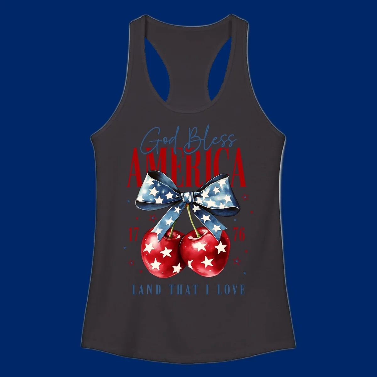 A patriotic design featuring 'God Bless AMERICA' and 'LAND THAT I LOVE' with a blue star-spangled bow, two red star-covered cherries, and the numbers '17' and '76'. god-bless-america-cherries.