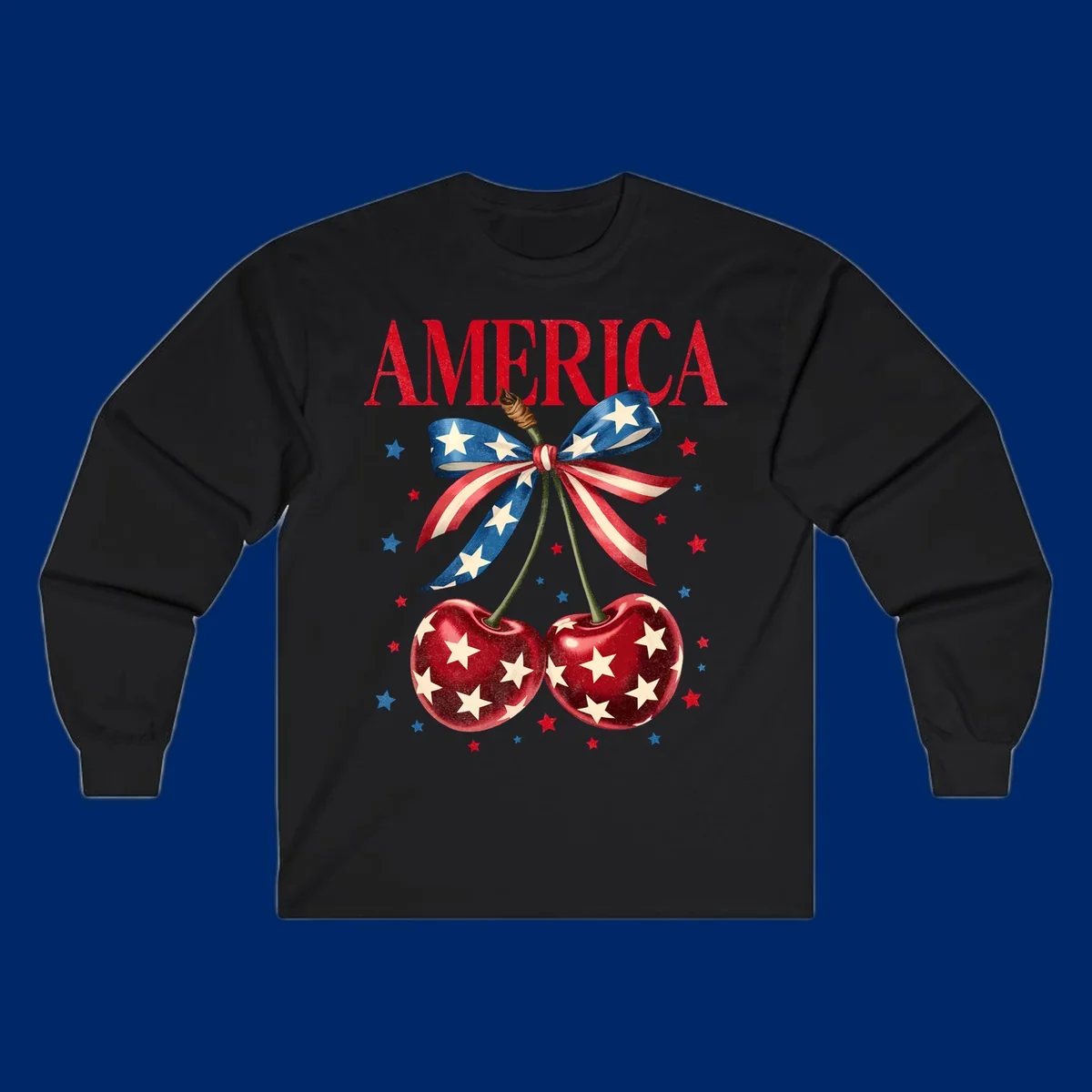 Vintage patriotic artwork featuring red 'AMERICA' text, two red cherries with white stars, and an American flag ribbon. Scattered red and blue stars complete this America-cherries-stars design.