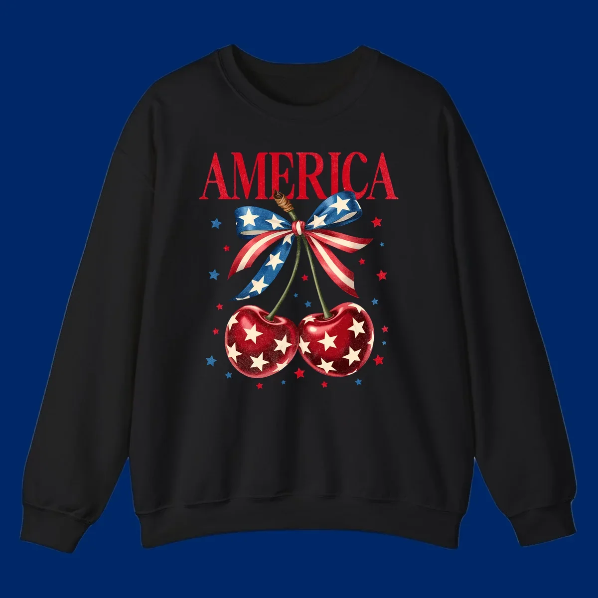 Vintage patriotic artwork featuring red 'AMERICA' text, two red cherries with white stars, and an American flag ribbon. Scattered red and blue stars complete this America-cherries-stars design.