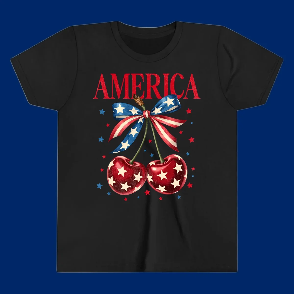 Vintage patriotic artwork featuring red 'AMERICA' text, two red cherries with white stars, and an American flag ribbon. Scattered red and blue stars complete this America-cherries-stars design.
