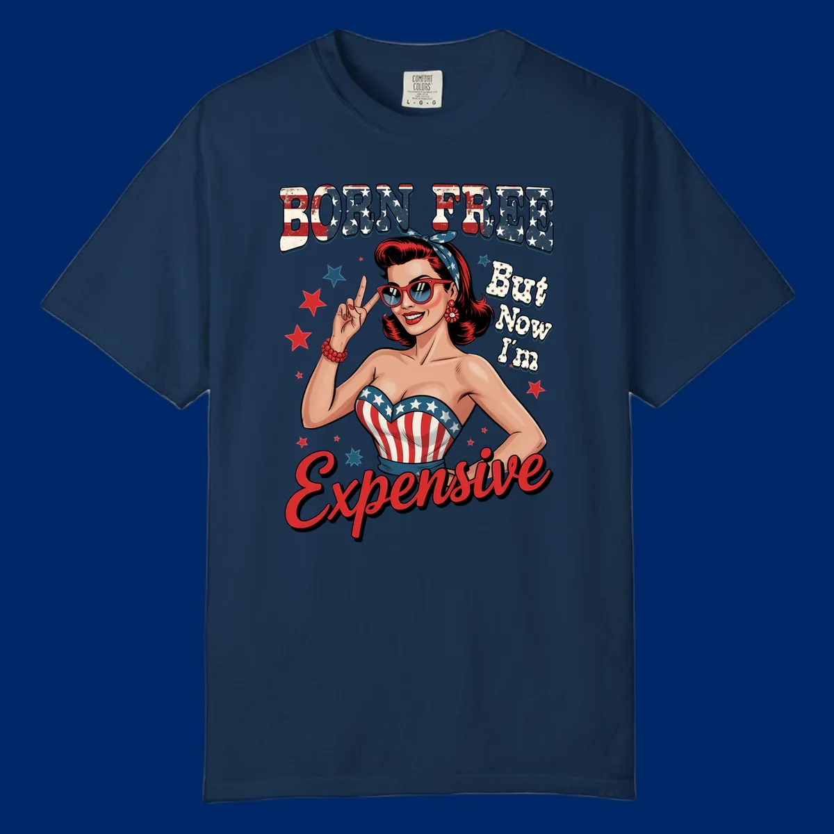 Retro pin-up girl making a peace sign, wearing a stars and stripes top, with the text 'BORN FREE But Now I'm Expensive'. This born-free-expensive-pin-up design is patriotic and fun.