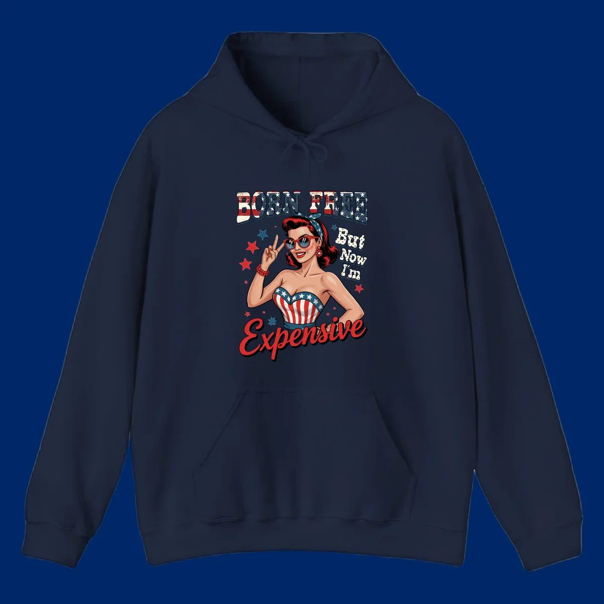 Retro pin-up girl making a peace sign, wearing a stars and stripes top, with the text 'BORN FREE But Now I'm Expensive'. This born-free-expensive-pin-up design is patriotic and fun.