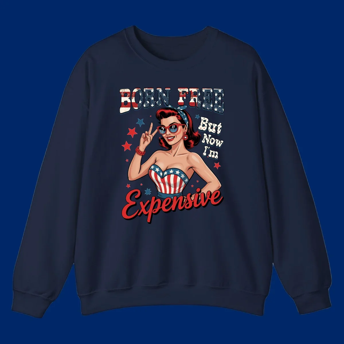 Retro pin-up girl making a peace sign, wearing a stars and stripes top, with the text 'BORN FREE But Now I'm Expensive'. This born-free-expensive-pin-up design is patriotic and fun.
