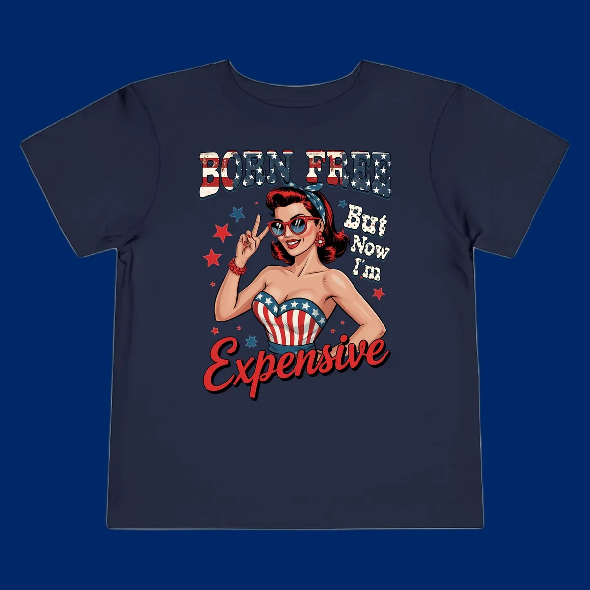 Retro pin-up girl making a peace sign, wearing a stars and stripes top, with the text 'BORN FREE But Now I'm Expensive'. This born-free-expensive-pin-up design is patriotic and fun.