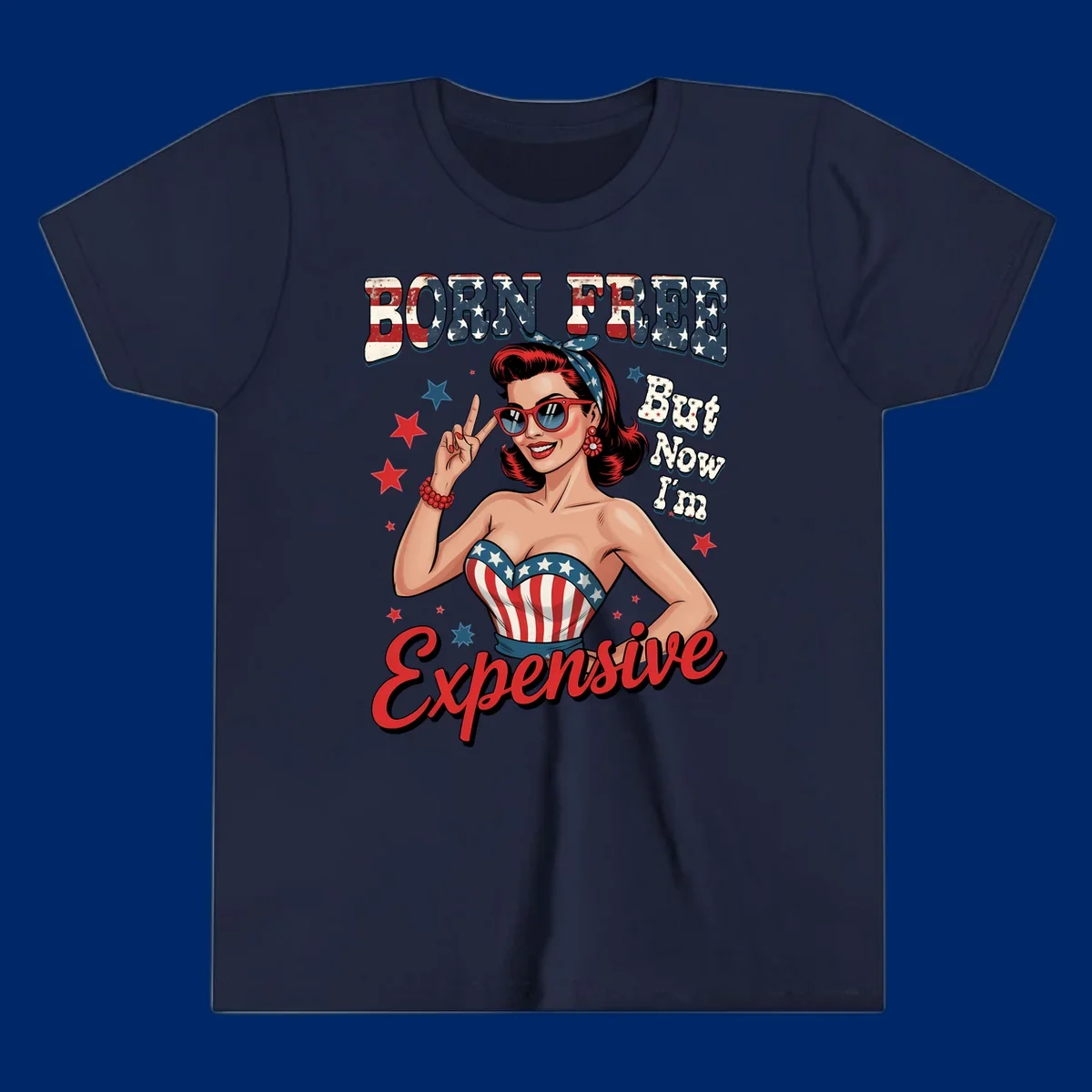 Retro pin-up girl making a peace sign, wearing a stars and stripes top, with the text 'BORN FREE But Now I'm Expensive'. This born-free-expensive-pin-up design is patriotic and fun.