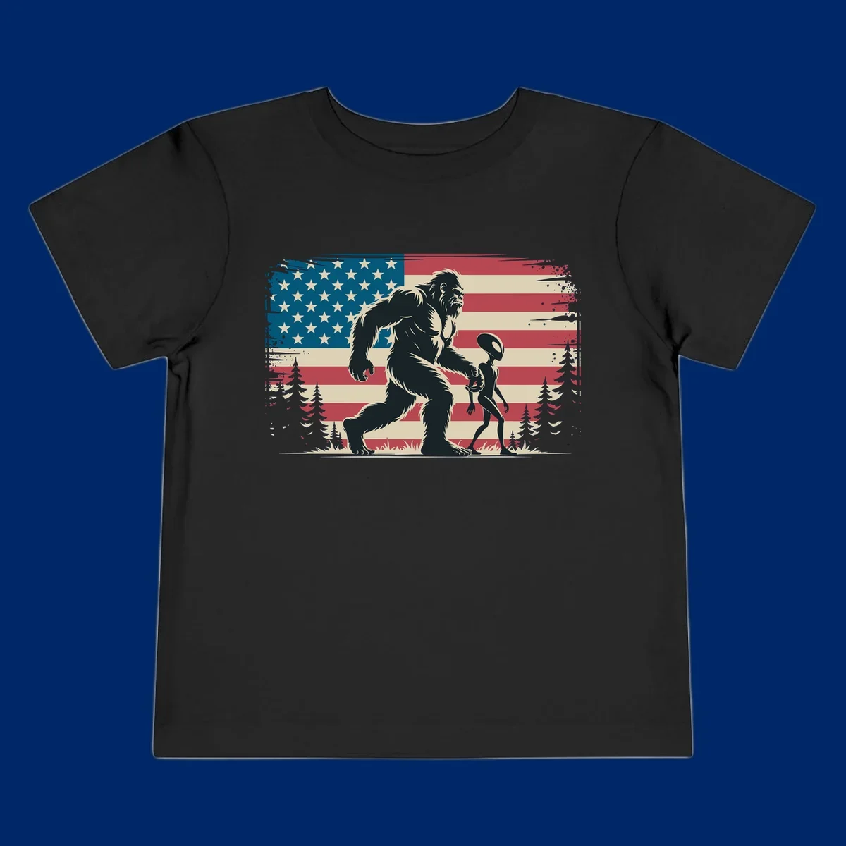 A vintage illustration of Bigfoot and a grey alien walking through a forest, set against a distressed bigfoot-alien-american-flag.
